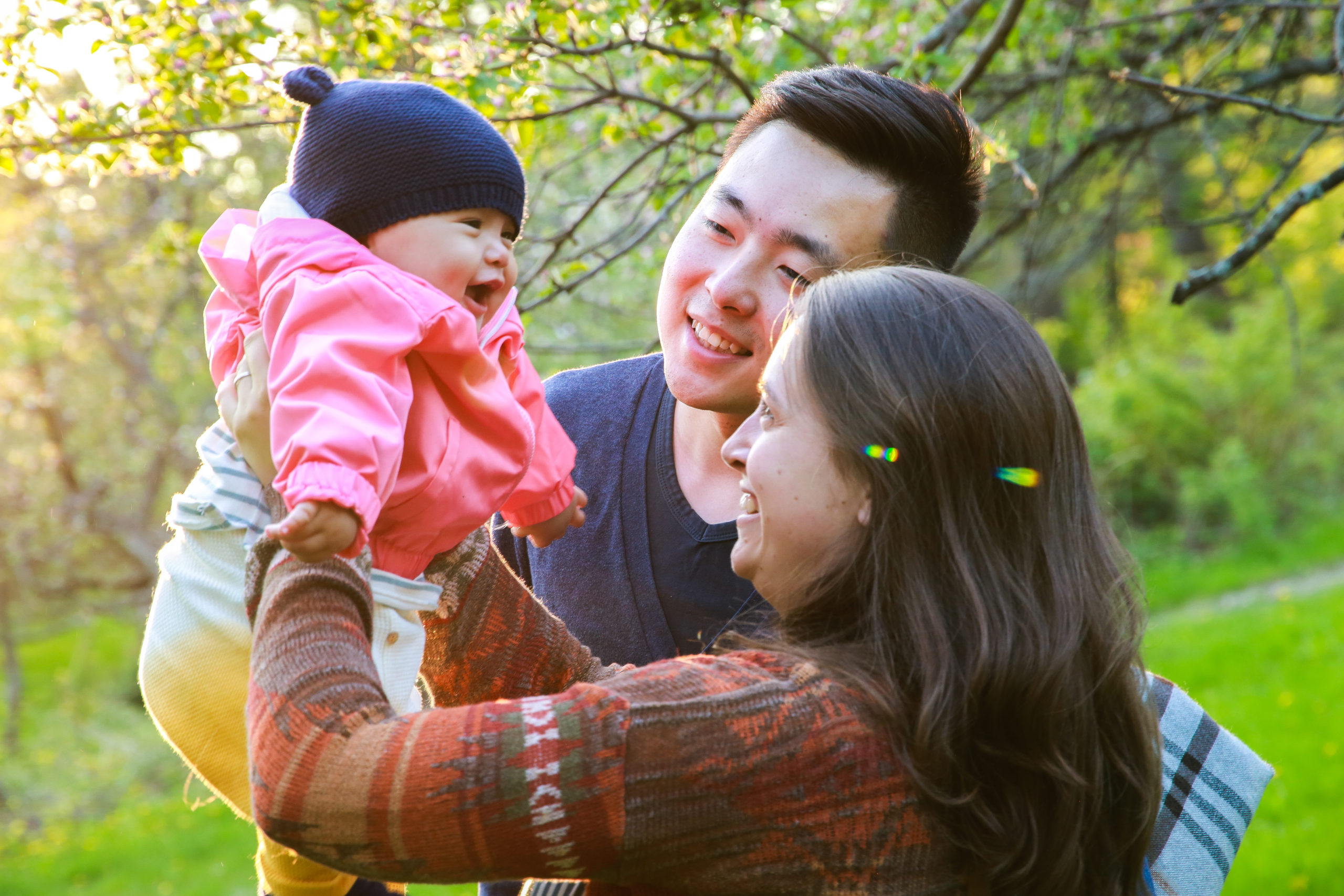 Xingy and Roxanne holding their mixed child