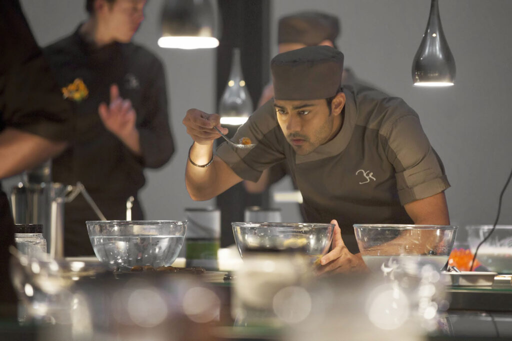 Hassan testing food in his Michelin Star kitchen in The Hundred-Foot Journey