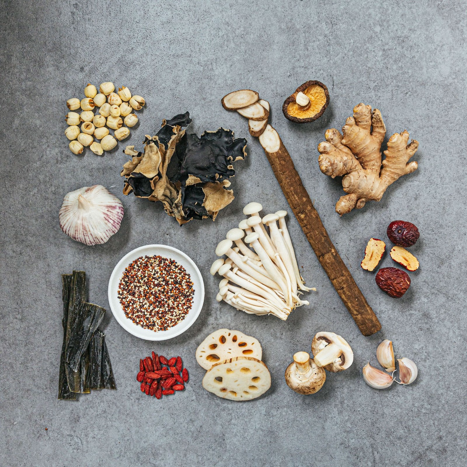 Reclaiming Chinese postpartum traditions with Feeding Mama. Display of dried ingredients used in Feeding Mama dishes such as multiple types of mushrooms, quinoa, lotus root, dates, ginger, and more.