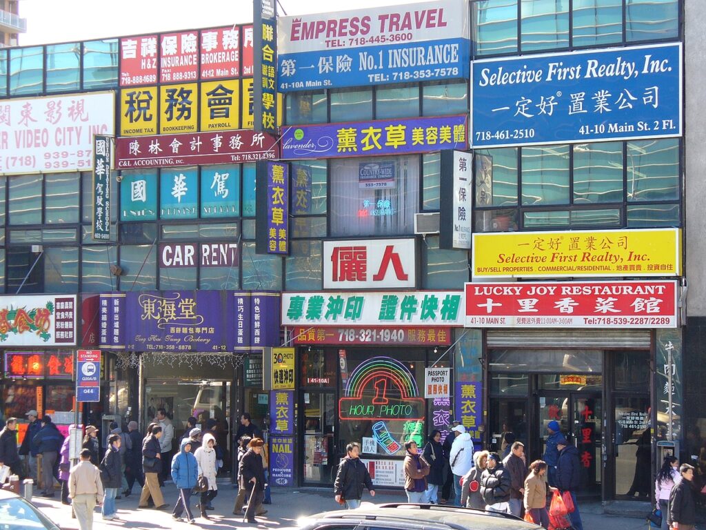 Image of a bustling NYC chinatown with many bystanders