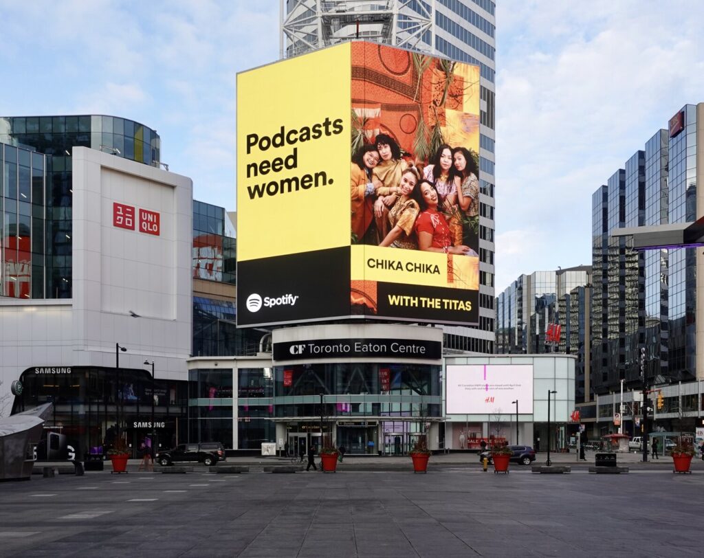 A big billboard that reads “Podcasts need women” with a picture of six Filipinas posing close to each other.