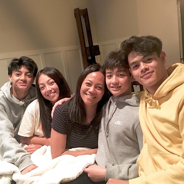 A mixed family: Filipina mother in between a son and daughter on the left and two more sons on her right. 