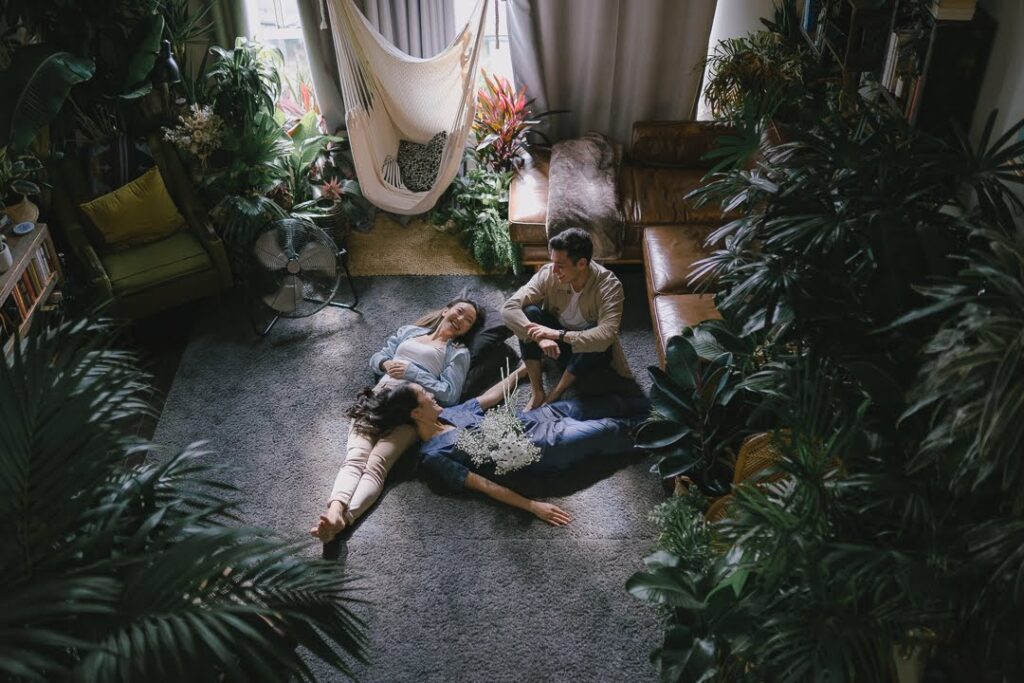 Selina Ho and two friends relaxing in a lush plant-filled office