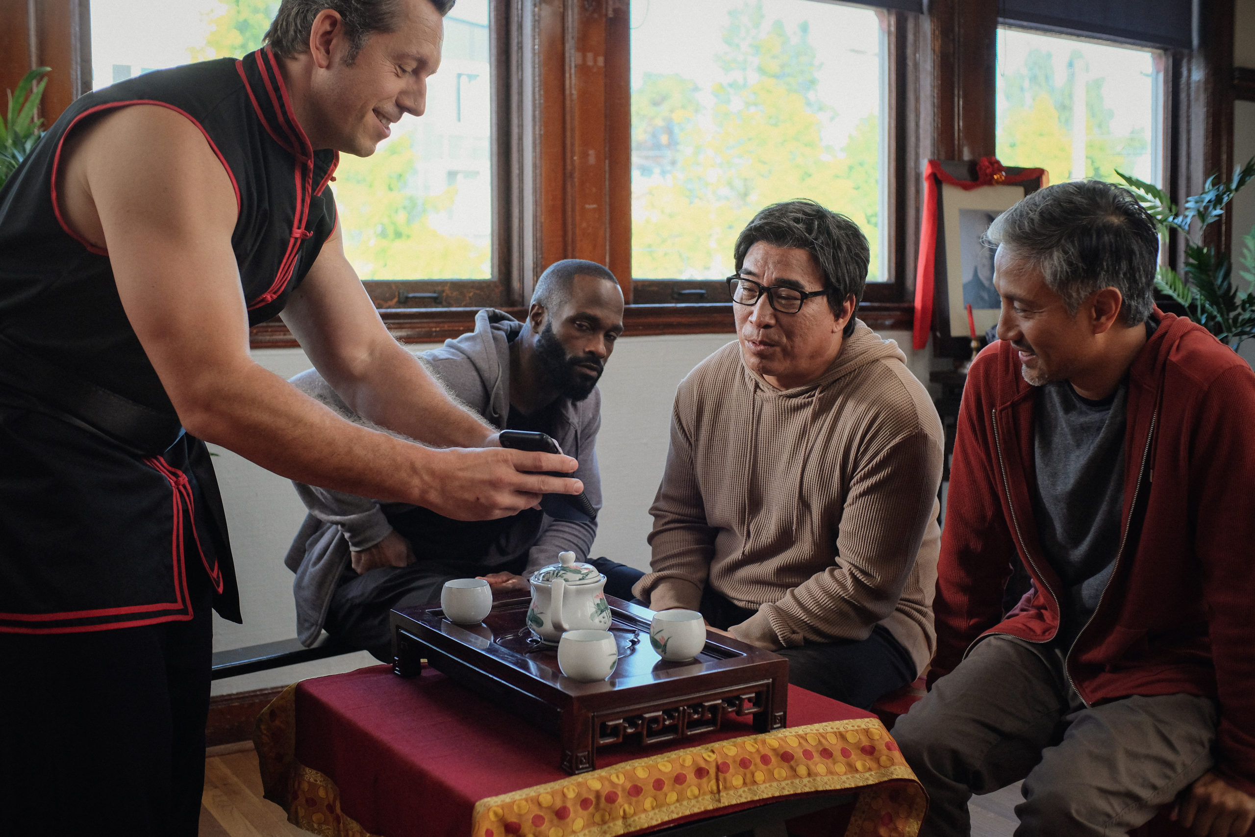 Matt Page, Mykel Shannon Jenkins, Ron Yuan, and Alain Uy having tea in The Paper Tigers film