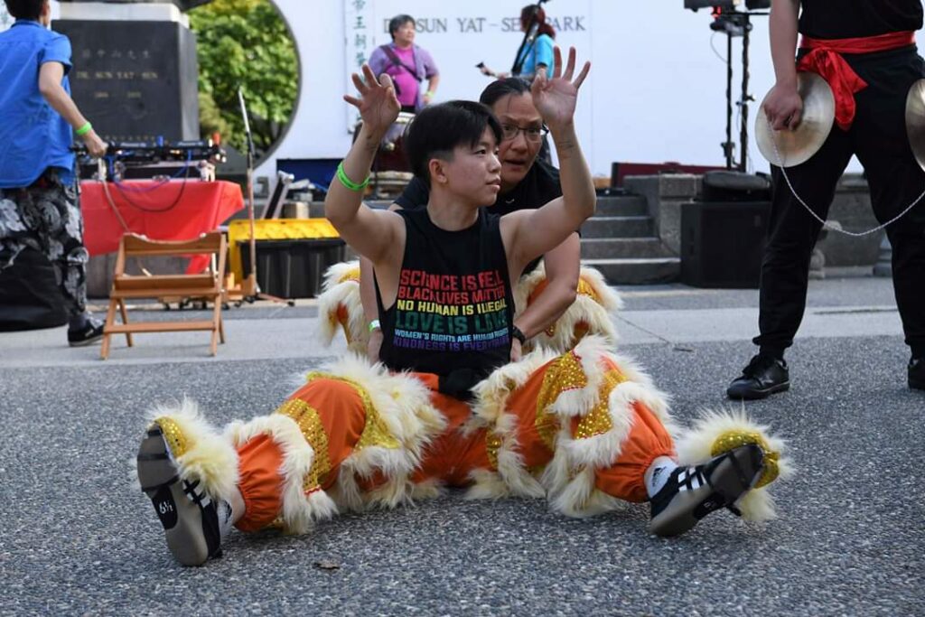 Dora Ng sits down as she gets ready to lion dance