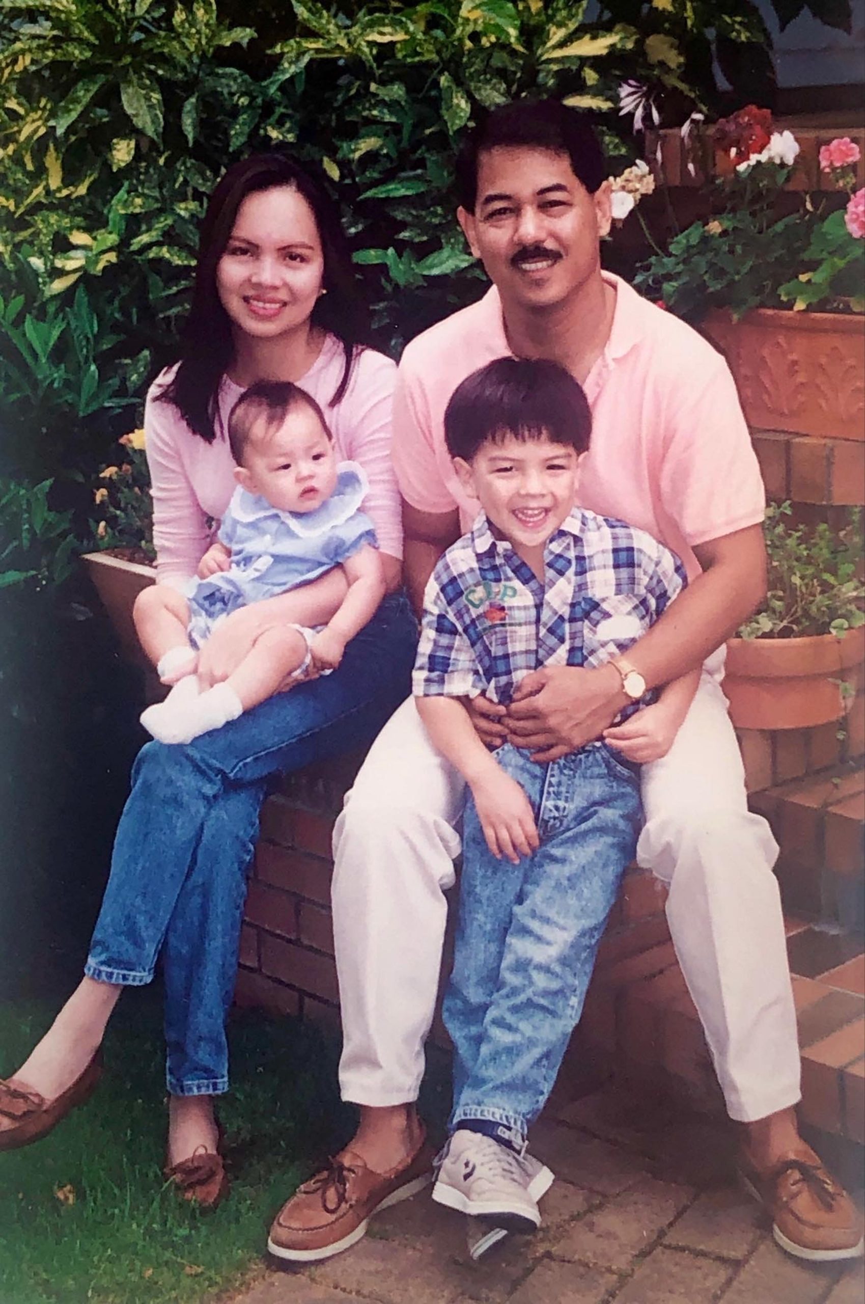 Michael Africa taking photo with his parents to show his Filipino roots.