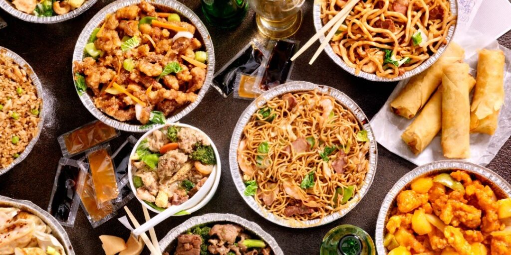Dishes of takeout food on a table