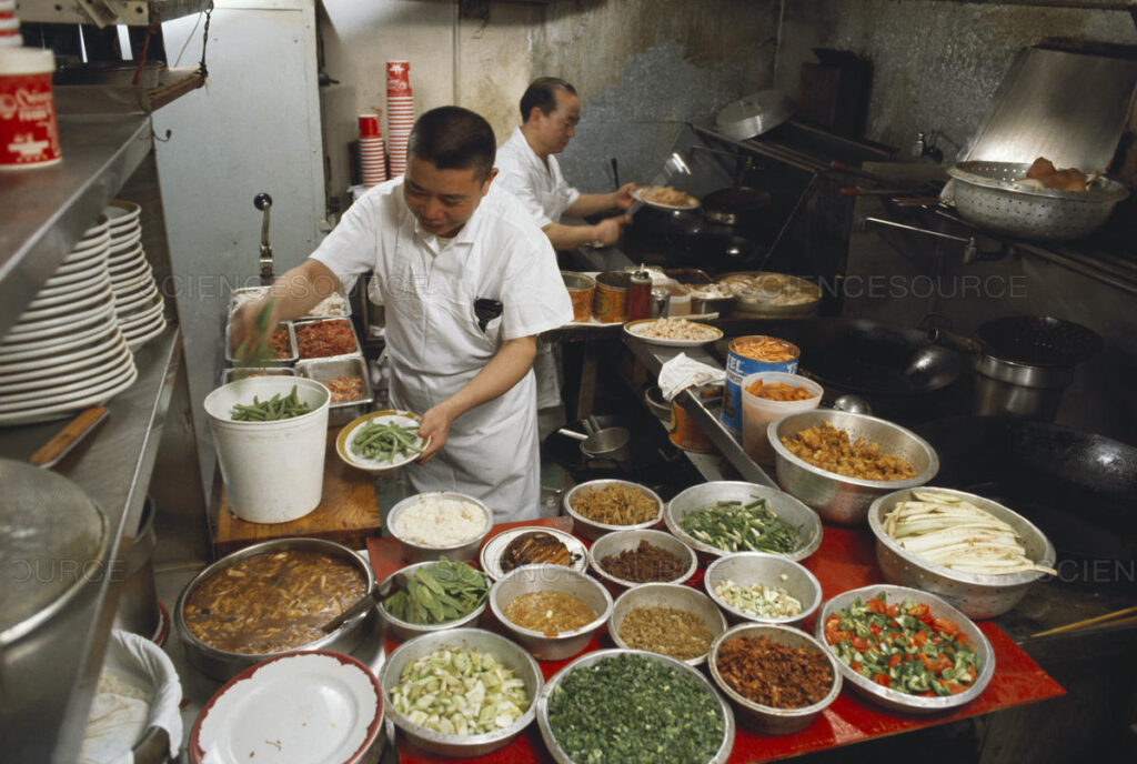 Cooks preparing takeout food in a kitchen