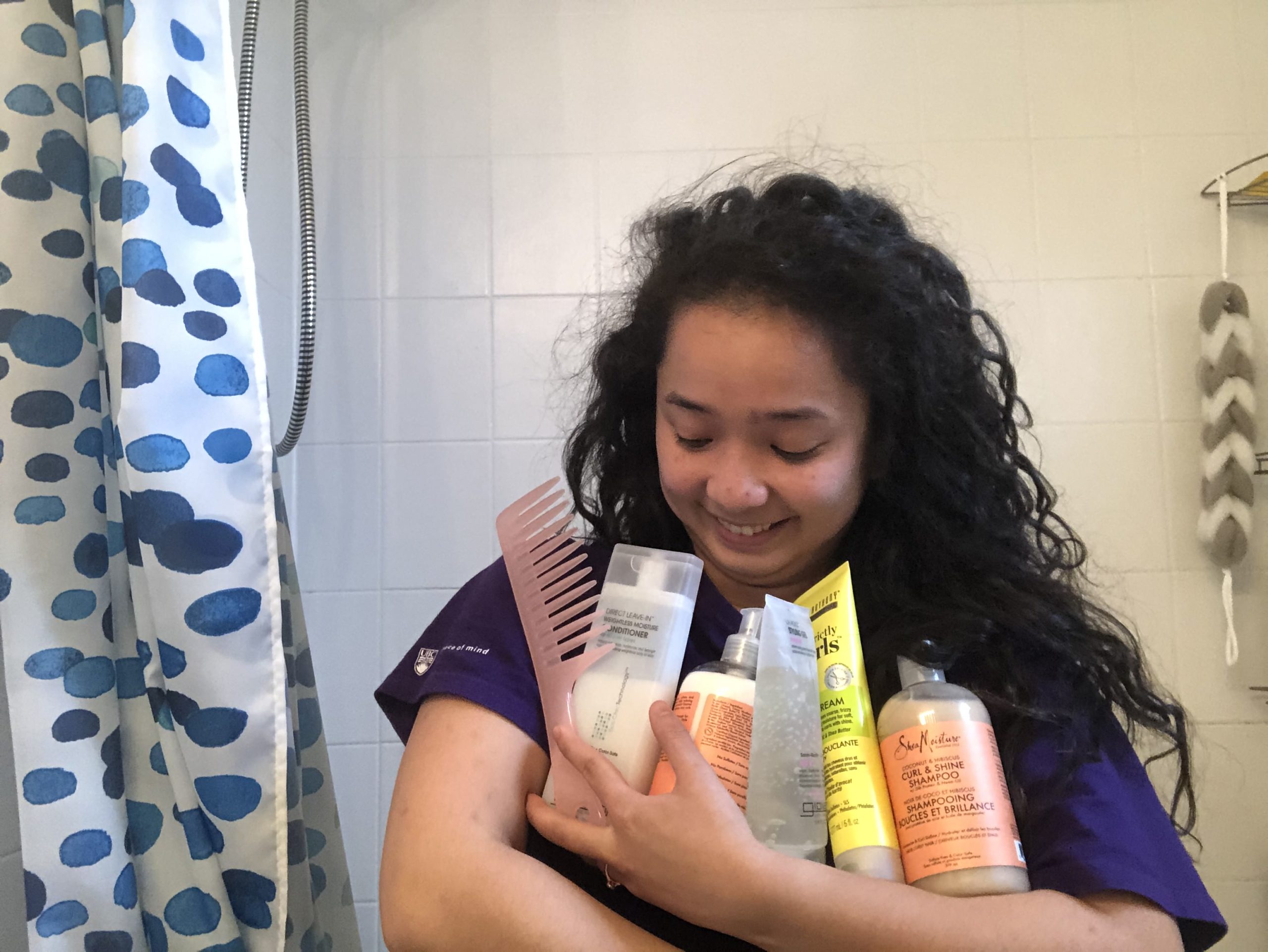 Author holding curly girl products