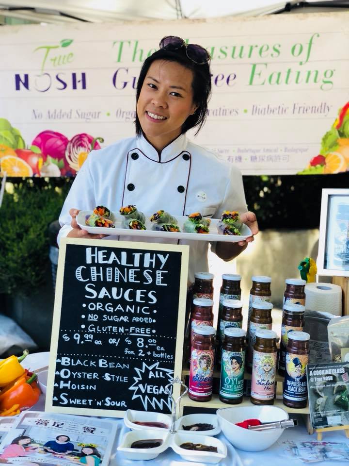 True NOSH owner Renée Chan displays her company's organic Chinese food products at a stand.