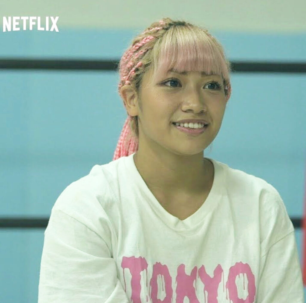 Screenshot from Netflix of Hana Kimura wearing white t-shirt