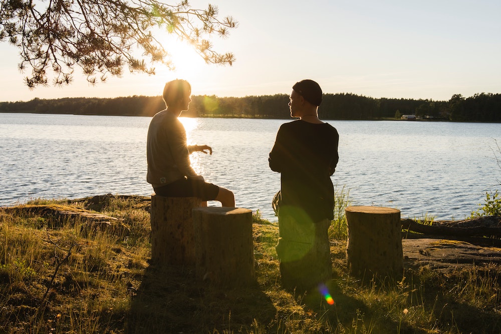 Two people talking at sunset
