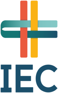 The logo for IEC Care features an abstract, multicolored design with interlocking shapes in red, yellow, teal, and blue, forming a cross-like pattern. The design is set against a deep blue background, representing interconnectedness, support, and care. Below the design, the text "IEC Care" is displayed, emphasizing the organization's focus on health and community services.