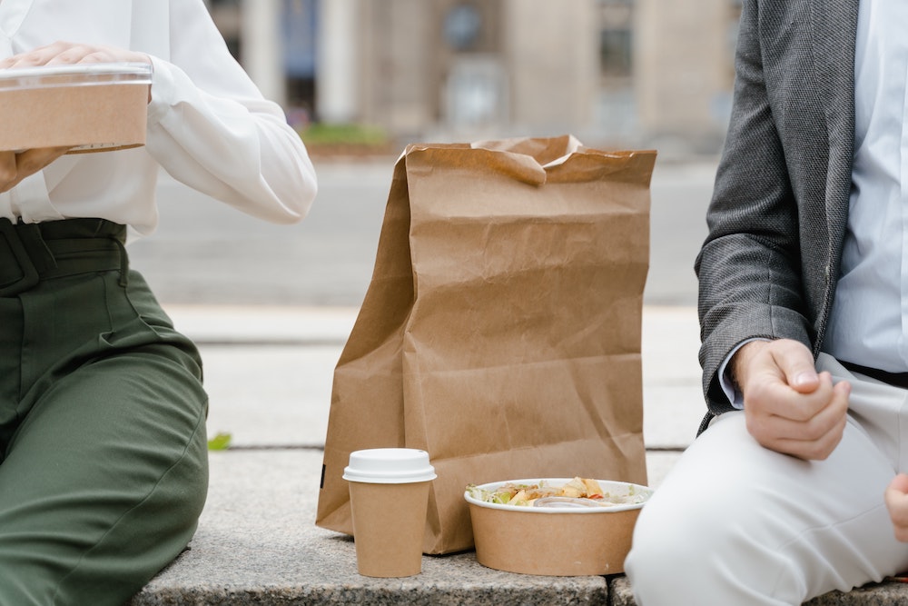 A lunchbag sitting between two people