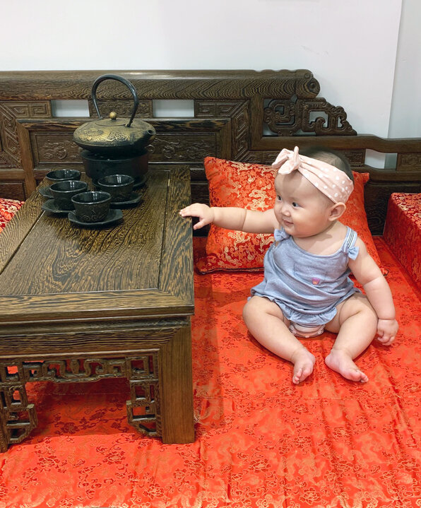 Cecilia Huang's daughter, Rylee, admires a tea set.