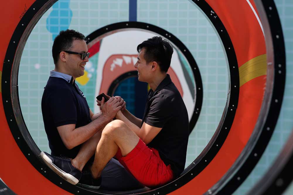 Gerald and Ryan, a gay couple, holding hands in Quebec