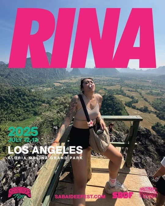 A promotional poster for Sabaidee Fest 2025 featuring Sarina, who stands confidently on a wooden lookout platform overlooking a vast, lush green valley and mountains under a clear blue sky. She wears a beige crop top, black shorts, a crossbody bag, and pink socks, exuding carefree energy. Large bold pink text at the top reads "RINA." Below, the event details are listed: "2025 July 12–13, Los Angeles, Gloria Molina Grand Park." Logos for Sabaidee Fest, SBDF, and Southeast Asian Street Market appear at the bottom.